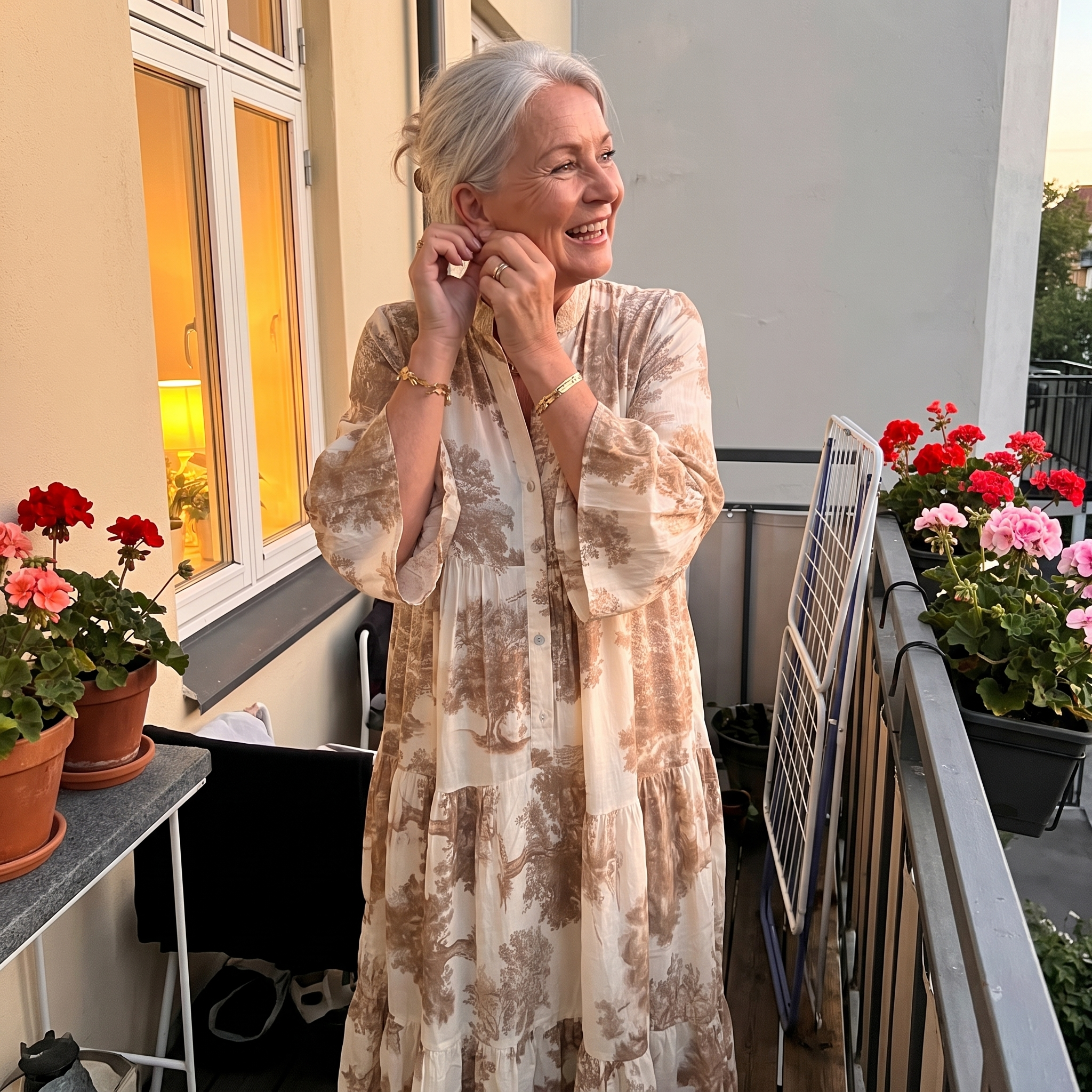 Customer wearing the Ophelia printed maxi dress on a balcony at dusk
